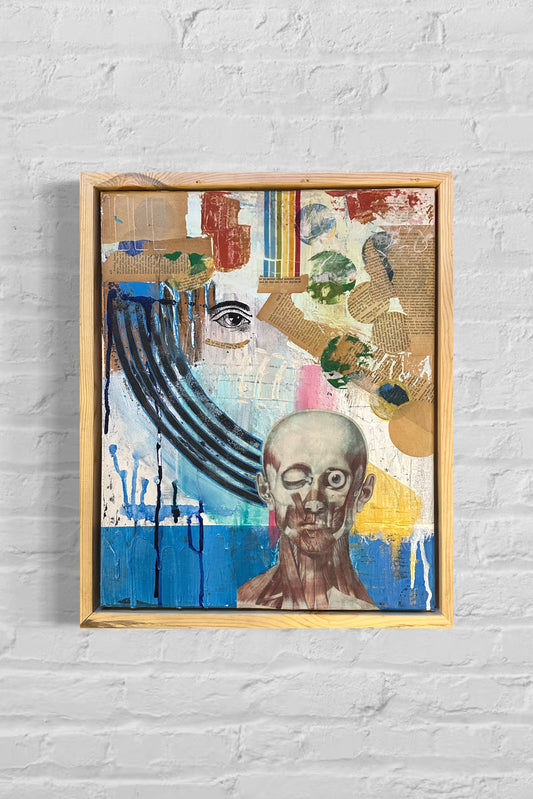 Framed abstract artwork with a portrait on a white brick wall