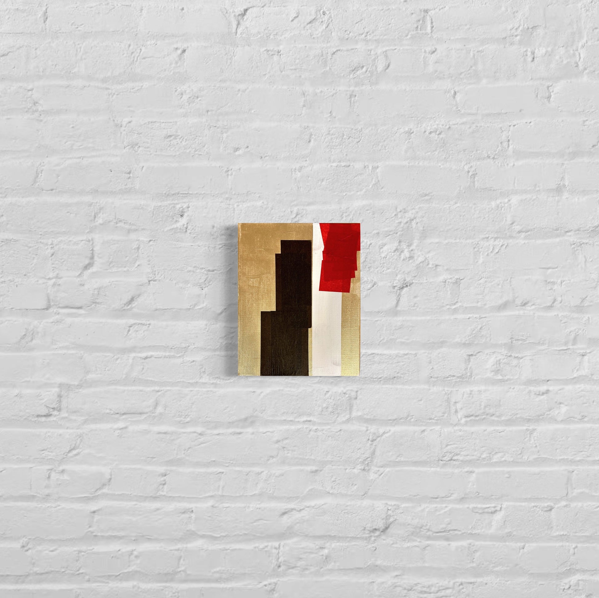 Abstract art piece with geometric shapes on a white brick wall