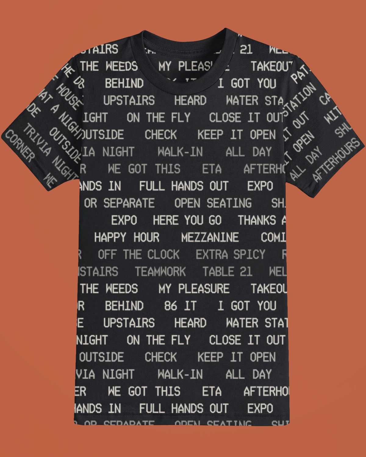 Service floor language printed on a black tee, shot on Oven orange