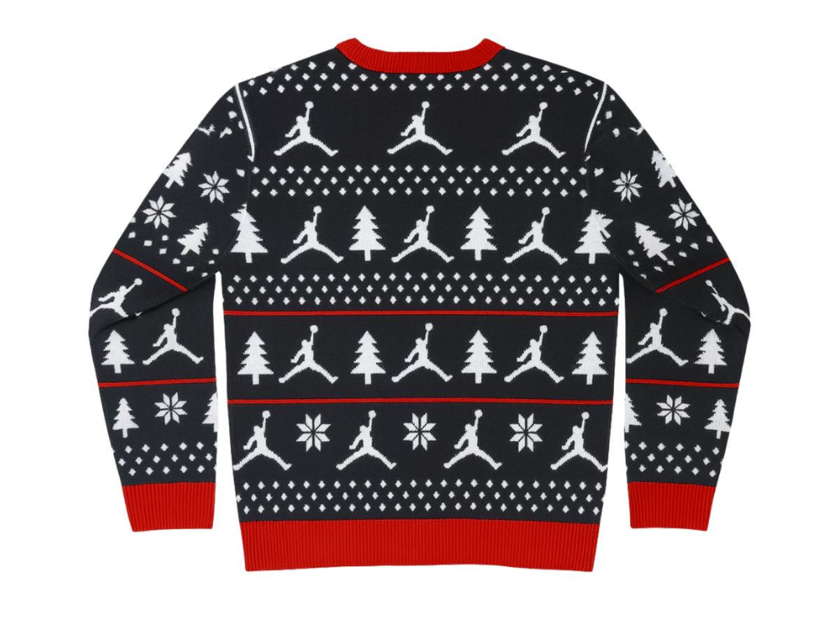 Jordan holiday jacquard sweater flat: Jumpman, tree, and snowflake rows on navy with red ribbing